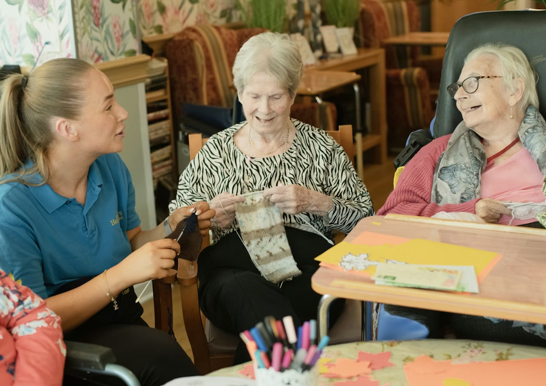 Caregiver spending quality time with two seniors to support daily wellbeing and independence in Gloucester County, NJ.